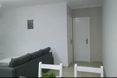 a living room with a couch and two white chairs at Villa la Parra in Chiclana de la Frontera