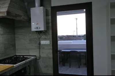 a door to a kitchen with a view of a table at Villa la Parra in Chiclana de la Frontera