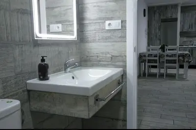 a bathroom with a sink with a soap dispenser on it at Villa la Parra in Chiclana de la Frontera