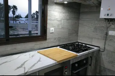 a kitchen with a stove and a counter top at Villa la Parra in Chiclana de la Frontera