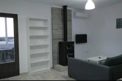 a living room with a couch and a tv at Villa la Parra in Chiclana de la Frontera