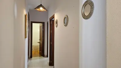 a bedroom with a bed with two towels on it at CASA BLANCA-Parking gratis in Sanlúcar de Barrameda