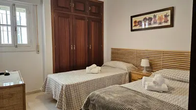 a living room with a couch and a table at CASA BLANCA-Parking gratis in Sanlúcar de Barrameda