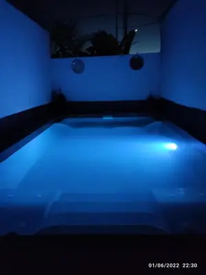 a blue lighted bed in a dark room at Villa egipto con jacuzzi y piscina climatizada in Chiclana de la Frontera