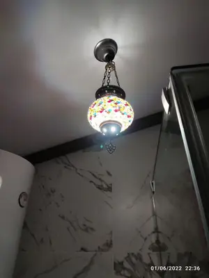 a ceiling light with a sprinklesles light in a bathroom at Villa egipto con jacuzzi y piscina climatizada in Chiclana de la Frontera