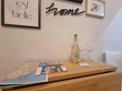 a table with a bottle of wine and a magazine at Terra Centro Cádiz in Cádiz