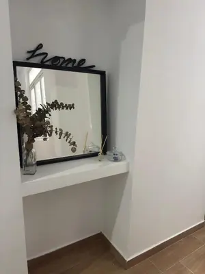 a mirror on a white wall in a room at Terra Centro Cádiz in Cádiz