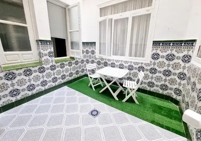 a patio with two chairs and a table on a house at Terra Centro Cádiz in Cádiz