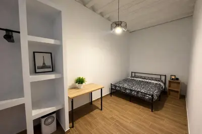 a bedroom with a bed and a desk in a room at Terra Centro Cádiz in Cádiz