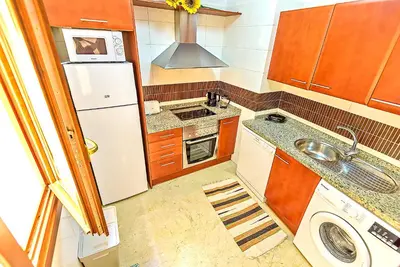 a kitchen with a white refrigerator and a sink at Ribera De Luxe Central Apartment with Ascensor in El Puerto de Santa María