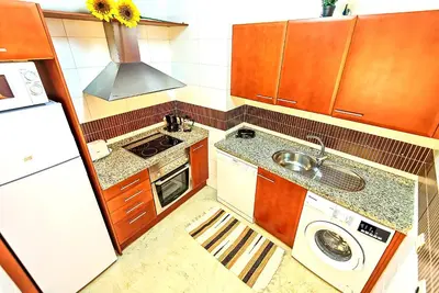 a small kitchen with a sink and a stove at Ribera De Luxe Central Apartment with Ascensor in El Puerto de Santa María