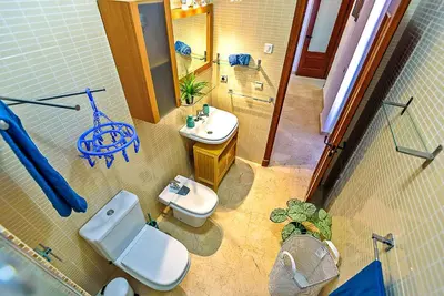 a bathroom with a white toilet and a sink at Ribera De Luxe Central Apartment with Ascensor in El Puerto de Santa María