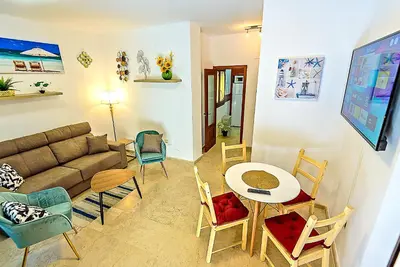 a living room with a couch and a table and chairs at Ribera De Luxe Central Apartment with Ascensor in El Puerto de Santa María