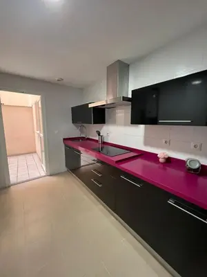 a kitchen with a red counter top in a room at Esteros de San Fernando in San Fernando