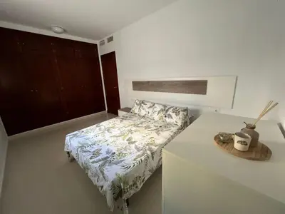 a small bedroom with a bed and a table at Esteros de San Fernando in San Fernando