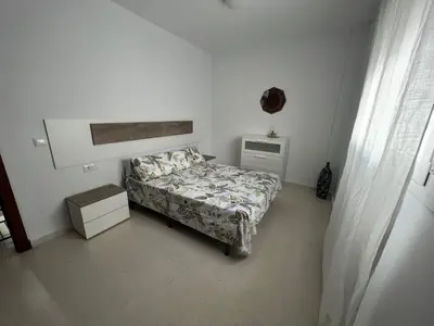 a bedroom with a bed and a table and a window at Esteros de San Fernando in San Fernando