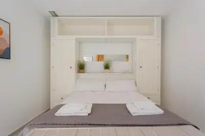 a bedroom with a bed with two towels on it at Atico del Buen CANTAOR by Cadiz4Rentals in Cádiz