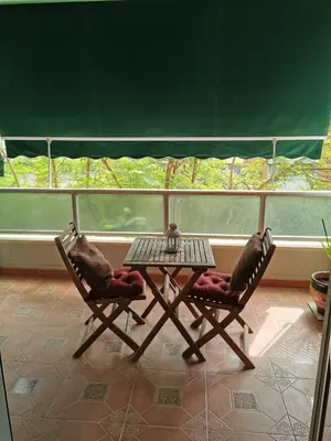 two chairs and a table in front of a balcony at Apartamento Playa Victoria in Cádiz
