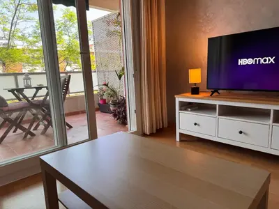 a living room with a television and a table at Apartamento Playa Victoria in Cádiz