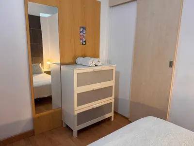 a bedroom with a dresser and a mirror at Apartamento Playa Victoria in Cádiz