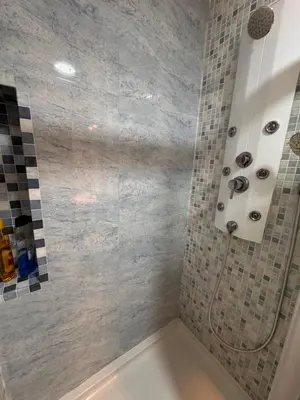 a bathroom with a shower with a white tub at Apartamento Playa Victoria in Cádiz