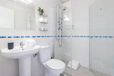 a bathroom with a toilet and a sink and a shower at Jerez Paralejo Ha Apartment in Jerez de la Frontera