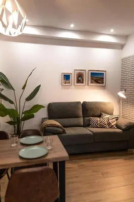 a living room with a couch and a table at Mina50 by 7Escalones in Rota