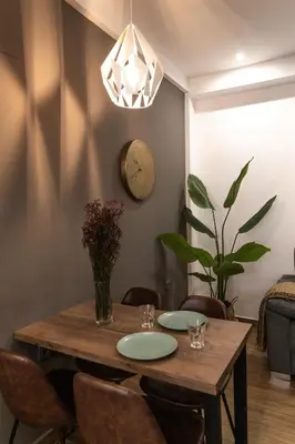 a dining room with a wooden table and chairs at Mina50 by 7Escalones in Rota