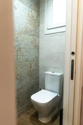 a white toilet in a bathroom with a window at Mina50 by 7Escalones in Rota