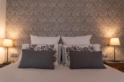a bedroom with a white bed with two pillows at Mina50 by 7Escalones in Rota