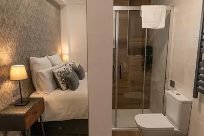 a bathroom with a bed with a glass shower at Mina50 by 7Escalones in Rota