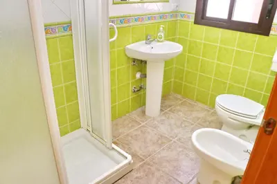 a bathroom with a toilet and a sink at Chalet Florida IV in Conil de la Frontera