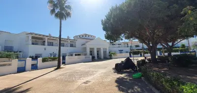a person laying on the ground in front of a building at Apartamento turístico la jara in Sanlúcar de Barrameda