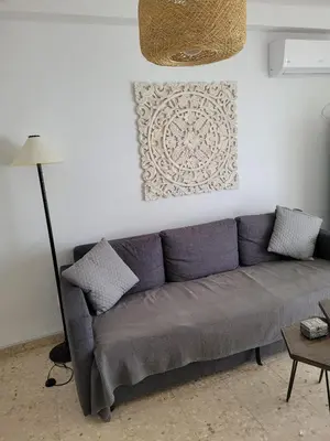 a living room with a couch and a lamp at La Costilla centro y playa in Rota