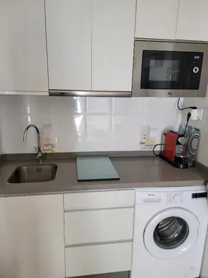 a kitchen with a washing machine and a sink at La Costilla centro y playa in Rota