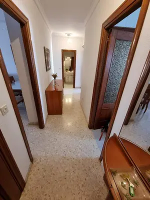 a bedroom with a large white bed and a chair at Gallegos House in Lebrija