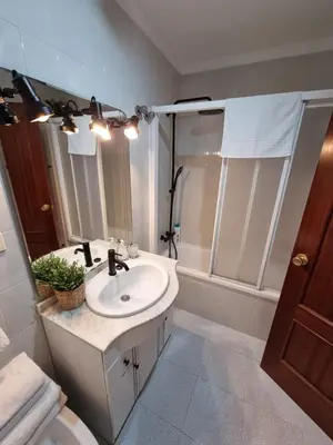 a bedroom with a large white bed and wooden cabinets at Gallegos House in Lebrija