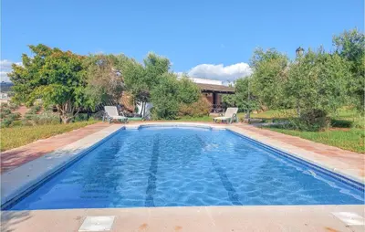 a swimming pool with two chairs and a house at Amazing Home In Arcos De La Frontera in Arcos de la Frontera
