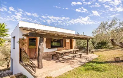 a house with a picnic table in the yard at Amazing Home In Arcos De La Frontera in Arcos de la Frontera