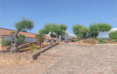 a house with trees and a stone driveway at Amazing Home In Arcos De La Frontera in Arcos de la Frontera