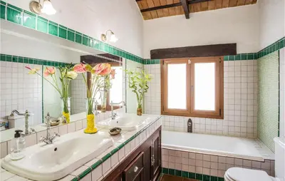 a bathroom with two sinks and a tub and a toilet at Amazing Home In Arcos De La Frontera in Arcos de la Frontera