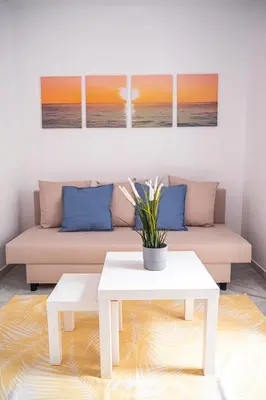 a living room with a couch and a table at Apartamento AGUAMAR in Sanlúcar de Barrameda