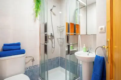a bathroom with a shower and a toilet and a sink at Apartamento centro Rota. 2 minutos de la playa.. in Rota