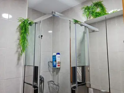 a bathroom with a shower with plants on the wall at Apartamento centro Rota. 2 minutos de la playa.. in Rota