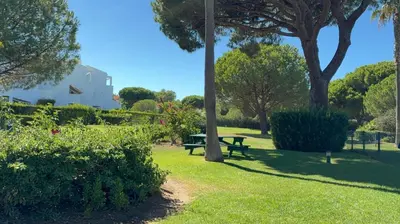 a park with a picnic table in the grass at Apartamento Retama Golf in Chiclana de la Frontera