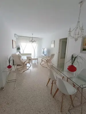 a living room with chairs and a glass table at Mirador Bajo de Guía in Sanlúcar de Barrameda