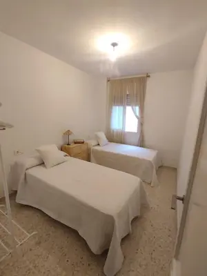 a bedroom with two beds and a window at Mirador Bajo de Guía in Sanlúcar de Barrameda