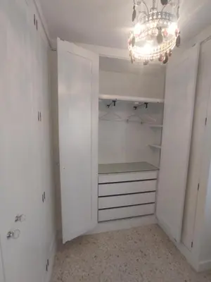 a white walk in closet with a chandelier at Mirador Bajo de Guía in Sanlúcar de Barrameda