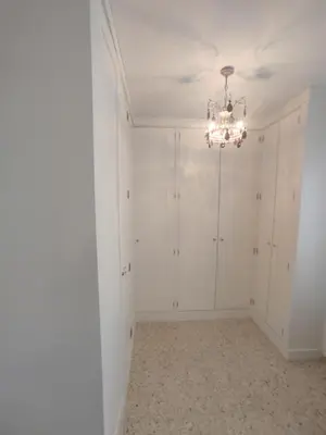 a room with white walls and a chandelier at Mirador Bajo de Guía in Sanlúcar de Barrameda