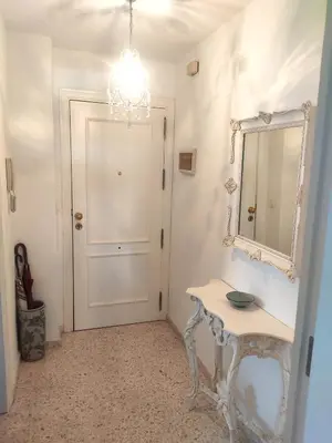 a hallway with a table and a mirror and a door at Mirador Bajo de Guía in Sanlúcar de Barrameda